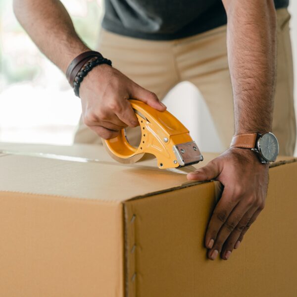 Man taping up a cardboard box